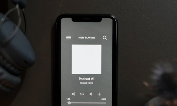 Close-up photo of iPhone showing a podcast playing on screen
